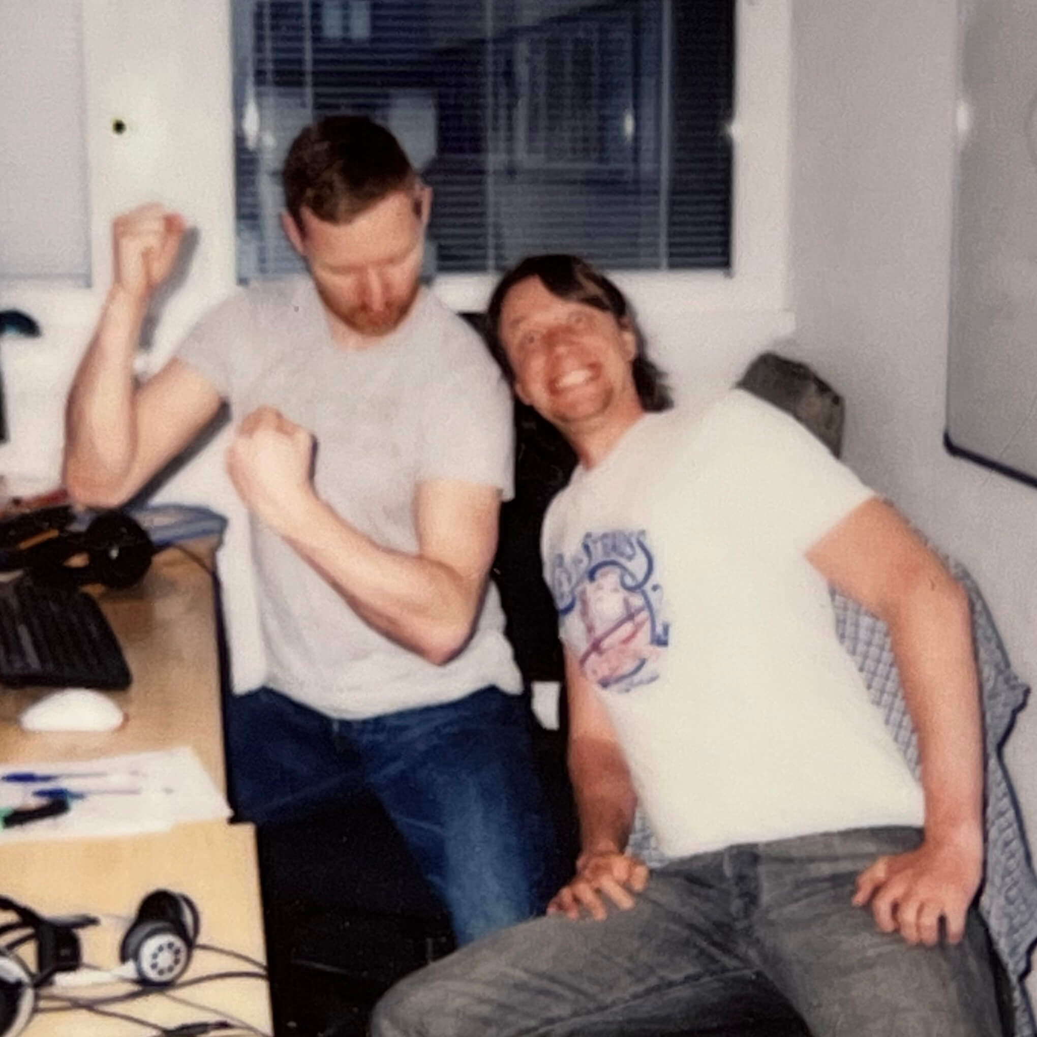 Two keen employees doing a funny muscle pose